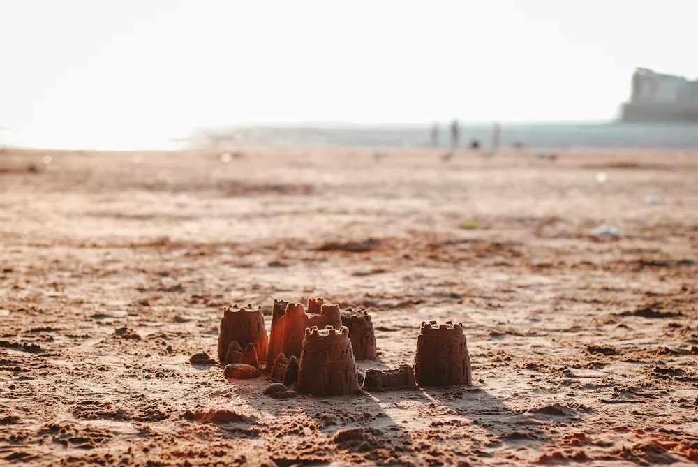 Sand castle at sunset on a calm beach