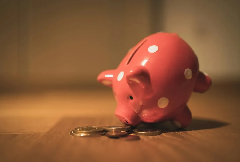 Piggy bank with coins for travel budget savings